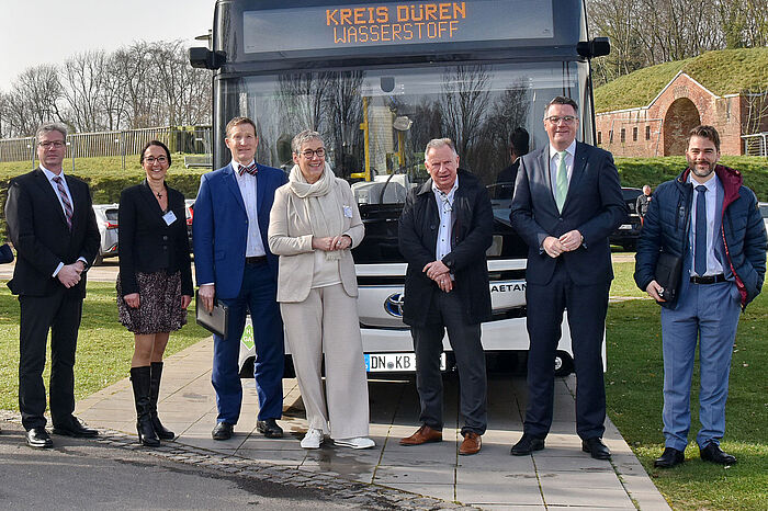 Gruppenfoto vor einem mit Wasserstoff betriebenen Bus: Achim Blindert, Anne Schüssler, Michael F. Bayer, Sibylle Keupen, Stephan Pusch, Dr. Tim Grüttemeier und Dr. Martin Robinius 