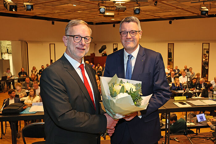 Zwei Männer mit einem Blumenstrauß.