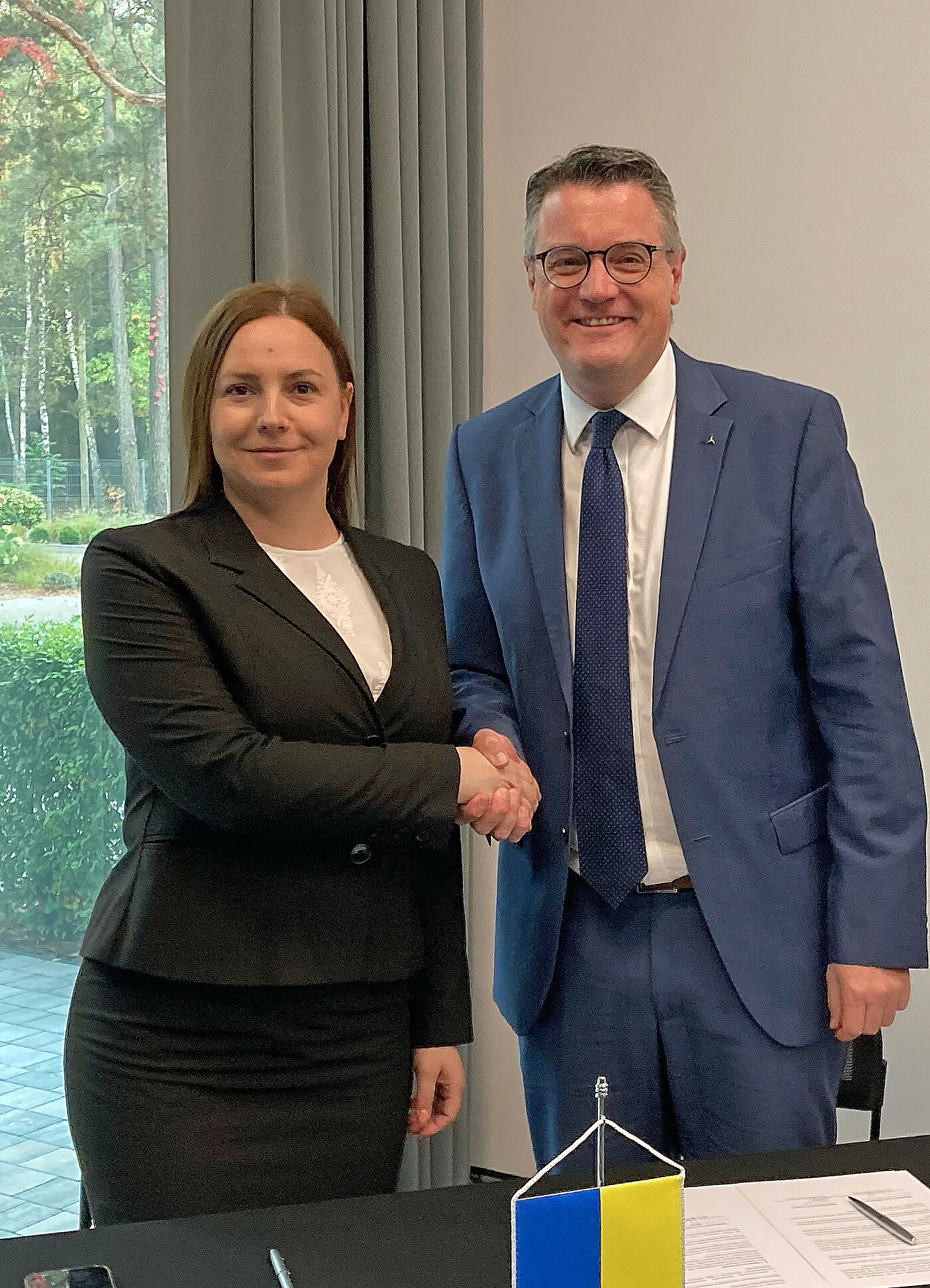 Die Landrätin des Rajon Lwiw, Khrystyna Zamula, und StädteRegionsrat Dr. Tim Grüttemeier geben sich die Hand.