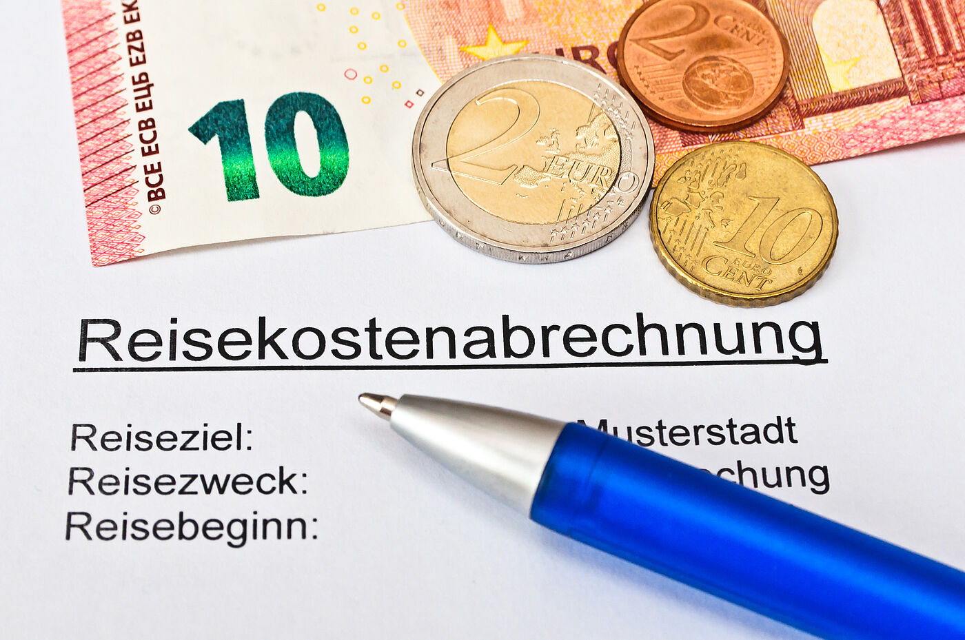 Reisekostenabrechnung, es ist ein 10 Euroschein abgesbildet und Kleingeld