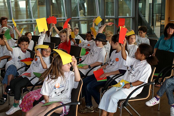 Kinder stimmen mit roten und gelben Karten ab